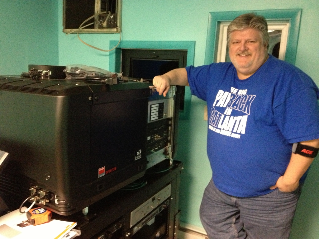 Tim Reed installs our digital projectors, 2014.