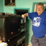 Tim Reed installs our digital projectors, 2014.