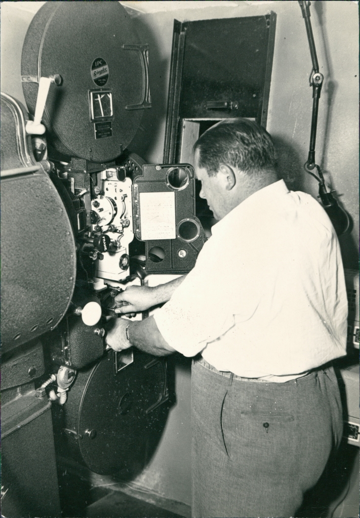 Becky doing what he liked to do best, making people happy by showing a movie.