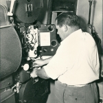 Becky doing what he liked to do best, making people happy by showing a movie.